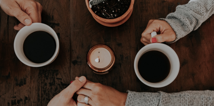 Supporting hands with coffee cups